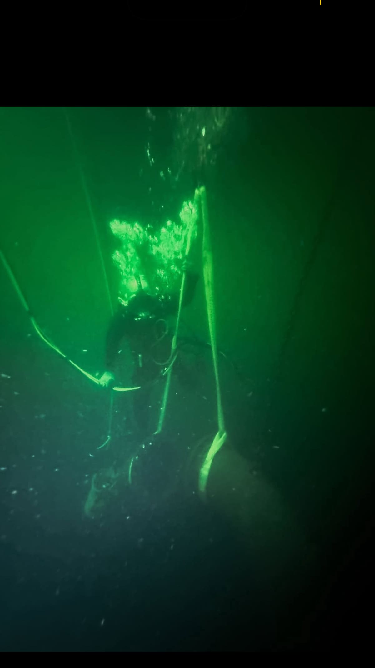 Diver working along guide lines on the floor of a water storage tank